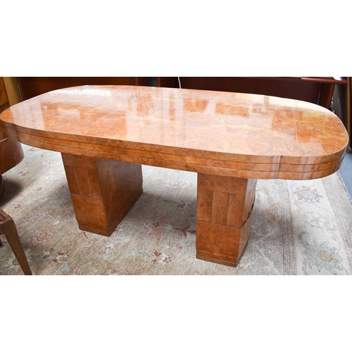 614 - Manner of Harry and Lou Epstein: An Art Deco maple dining table with rounded rectangular top, raised... 