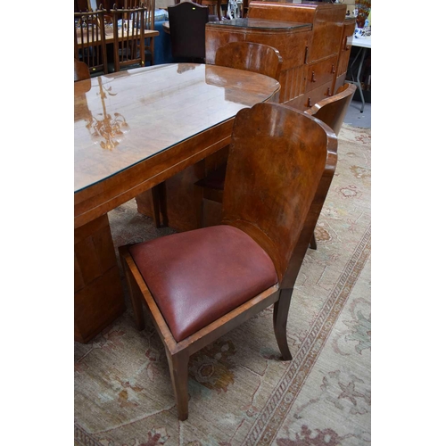 614 - Manner of Harry and Lou Epstein: An Art Deco maple dining table with rounded rectangular top, raised... 