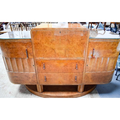 615 - Manner of Harry and Lou Epstein: An Art Deco maple drinks cabinet with the centre opening out to rev... 