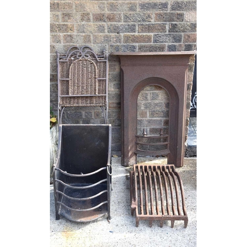 620 - An antique cast iron fire surround together with a pair of wrought iron folding seats and a fire gra... 