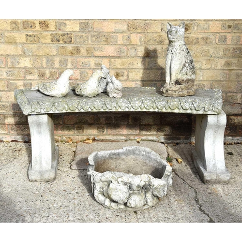 624 - A reconstituted stone bench together with a group of animals and a stone planter.