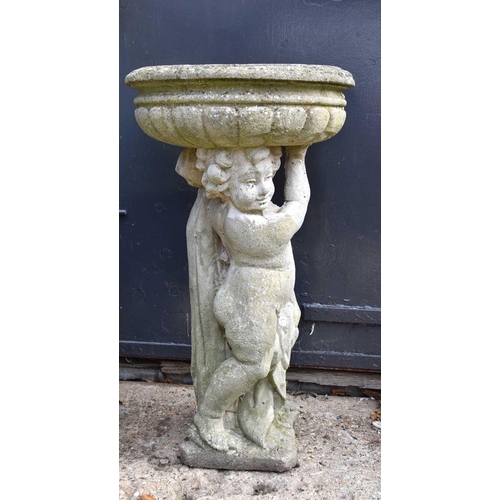 628 - A reconstituted stone bird bath,with cherub support, 89cm high.