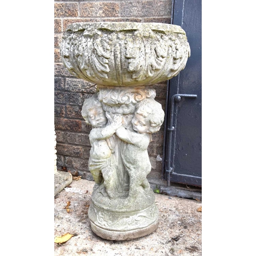 629 - A reconstituted stone birth with twin cherub support and acanthus leaf design, 84cm high.