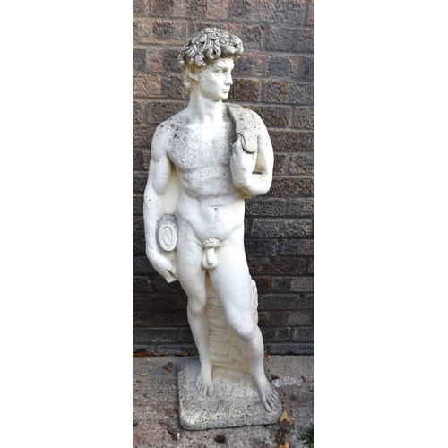 631 - A reconstituted stone statue of a standing male 