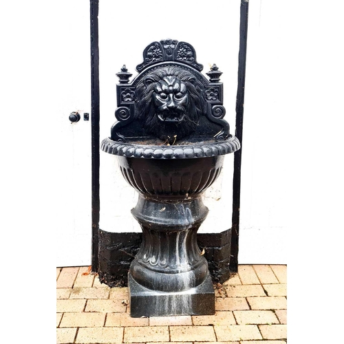 634 - Garden Statuary: A cast iron fountain, painted black, cast with a lion head spout.