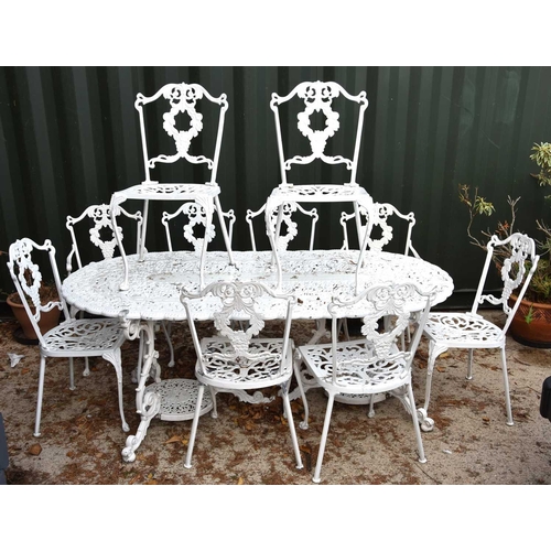 636 - A Regency-style painted aluminium garden table and set of ten chairs with grape motif.