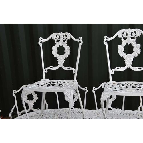 636 - A Regency-style painted aluminium garden table and set of ten chairs with grape motif.