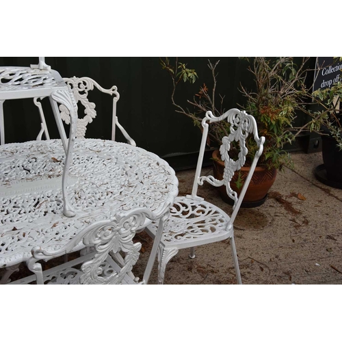 636 - A Regency-style painted aluminium garden table and set of ten chairs with grape motif.