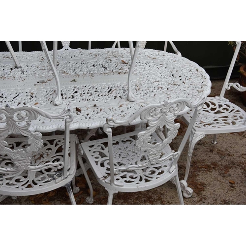 636 - A Regency-style painted aluminium garden table and set of ten chairs with grape motif.