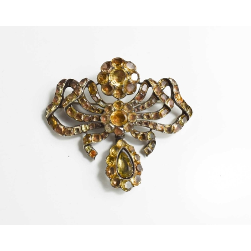 1 - A Georgian silver and yellow gem set metamorphic brooch pendant, in the form of a bow with flower he... 