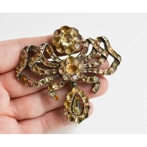 1 - A Georgian silver and yellow gem set metamorphic brooch pendant, in the form of a bow with flower he... 