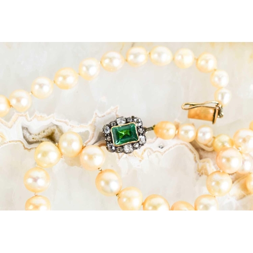 12 - A Georgian pearl necklace, with a gold (tested as 14ct) clasp set with a central emerald bordered by... 