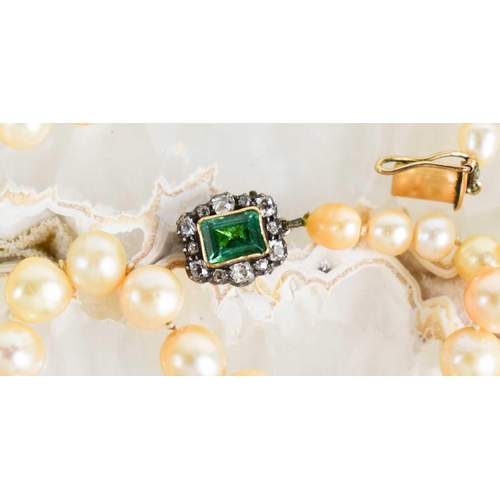 12 - A Georgian pearl necklace, with a gold (tested as 14ct) clasp set with a central emerald bordered by... 