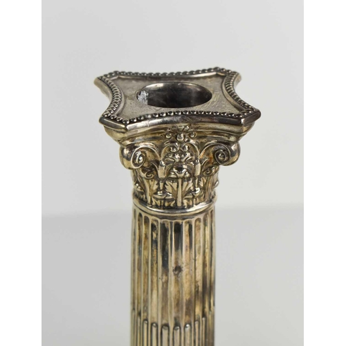 137 - A pair of silver candlesticks, in the form of Corinthian columns, by Walker & Hall, Sheffield 1923,w... 