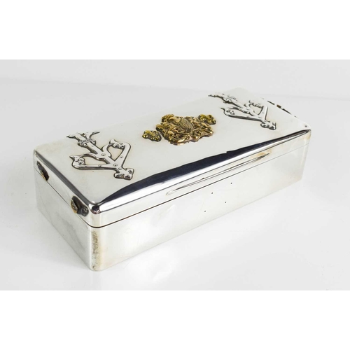 149 - A large silver cigarette box, London 1896, with embossed armorial decoration in brass to the top and... 