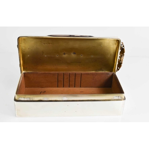 149 - A large silver cigarette box, London 1896, with embossed armorial decoration in brass to the top and... 