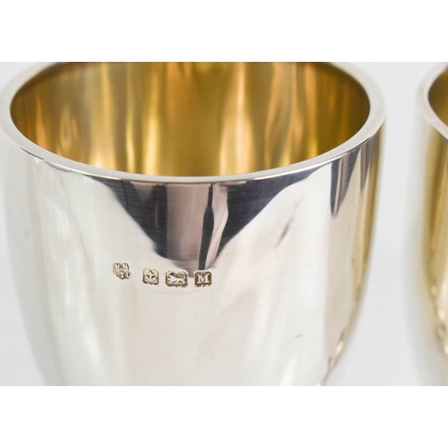 152 - A pair of silver goblets, Birmingham 1935, with residual gilded interiors, one bearing presentation ... 