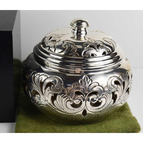 159 - A silver 800 grade pot pouri and cover, the body and lid embossed and engraved with scroll decoratio... 