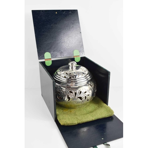 159 - A silver 800 grade pot pouri and cover, the body and lid embossed and engraved with scroll decoratio... 