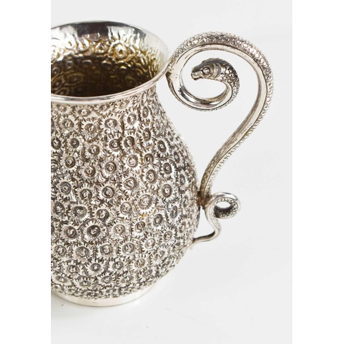 162 - A continental silver jug chased and repoussed with daises, and having a snake form handle, and havin... 