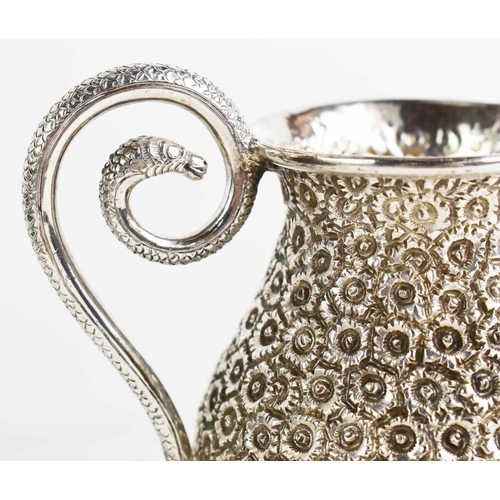 162 - A continental silver jug chased and repoussed with daises, and having a snake form handle, and havin... 