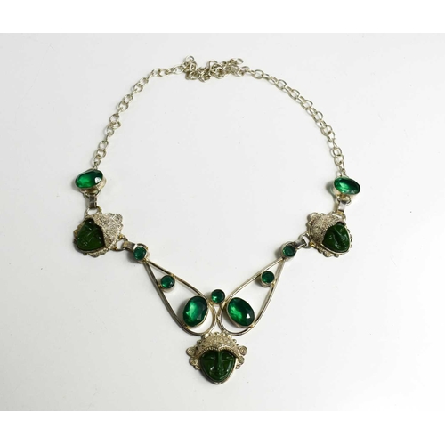 169 - A silver, jade and emerald style necklace, with three face masks, united by decorative framework set... 