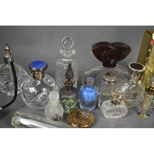 187 - A collection of vintage scent and perfume bottles including a circular cut glass bottle, the silver ... 