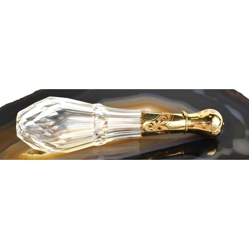 19 - A fine cut glass and gold plated scent bottle, the bulbous cover opens to reveal a silver mounted co... 