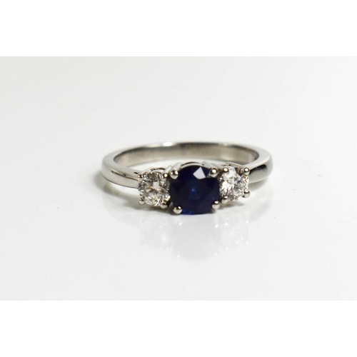 194 - A platinum, sapphire and diamond trilogy ring, size O, 5.8g.