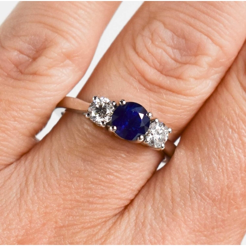 194 - A platinum, sapphire and diamond trilogy ring, size O, 5.8g.