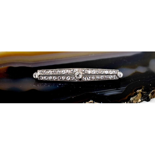 203 - An Art Deco 18ct white gold, platinum, and diamond bar brooch, set with a central diamond approximat... 