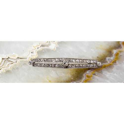 203 - An Art Deco 18ct white gold, platinum, and diamond bar brooch, set with a central diamond approximat... 