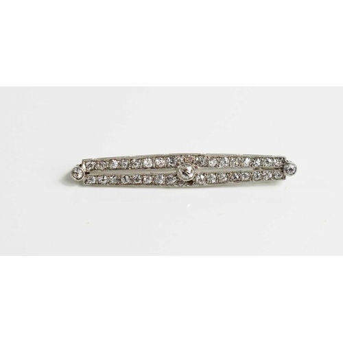 203 - An Art Deco 18ct white gold, platinum, and diamond bar brooch, set with a central diamond approximat... 