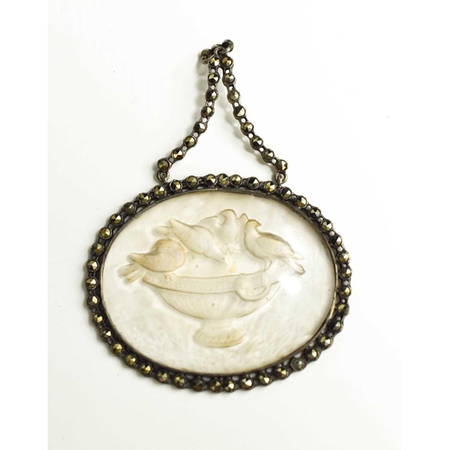 21 - A late Georgian marcasite and pressed glass pendant, depicting birds watering at an urn, with an iri... 