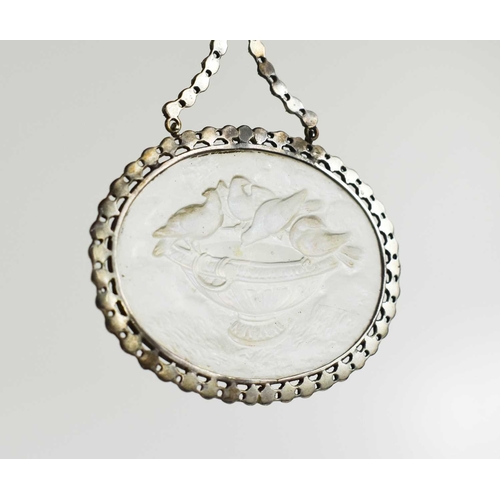 21 - A late Georgian marcasite and pressed glass pendant, depicting birds watering at an urn, with an iri... 