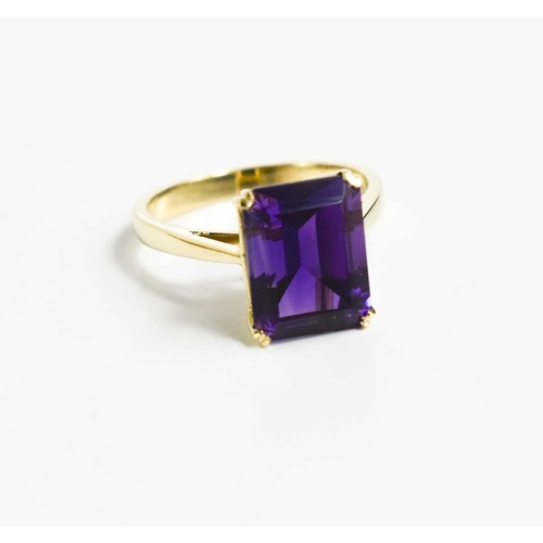 210 - A 9ct gold and amethyst cocktail ring, the emerald cut amethyst in four claw setting, size N, 3.6g.