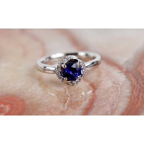 223 - An 18ct white gold, sapphire and diamond ring, size L½, 3.8g.