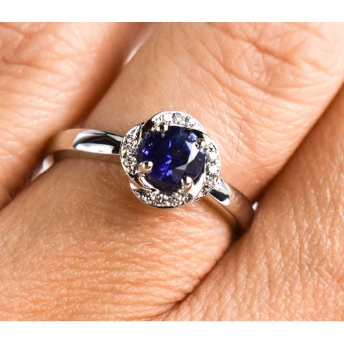 223 - An 18ct white gold, sapphire and diamond ring, size L½, 3.8g.