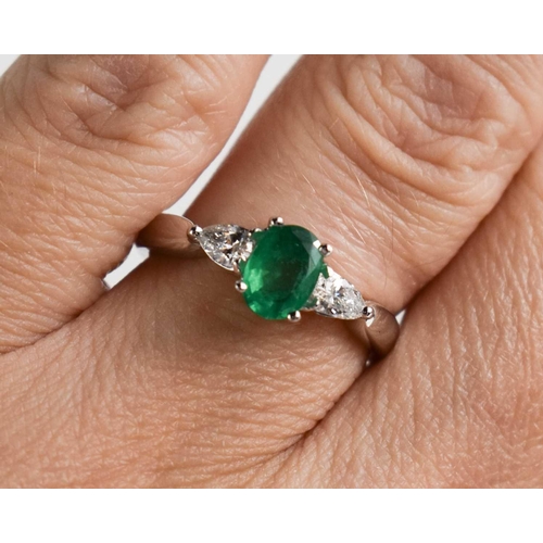 225 - An 18ct white gold, oval emerald and pear shaped diamond ring, size M, 3.8g.