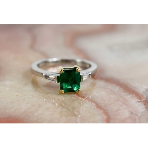 227 - A platinum and 18ct mounted emerald and diamond ring, size K, 4.3g.