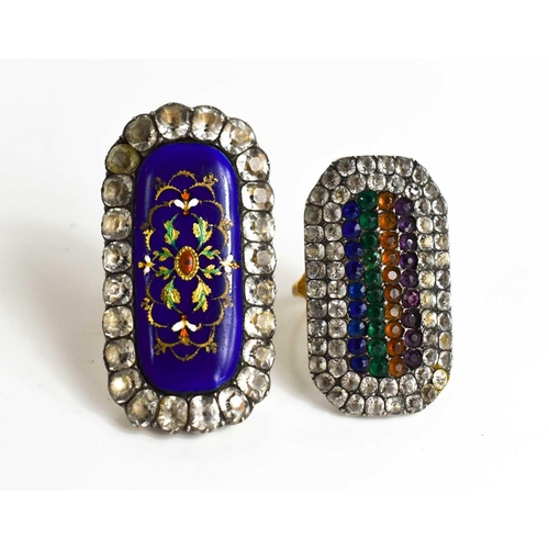 24 - Two Victorian white metal and paste set rings, one with blue enamel elongated oval centre embellishe... 