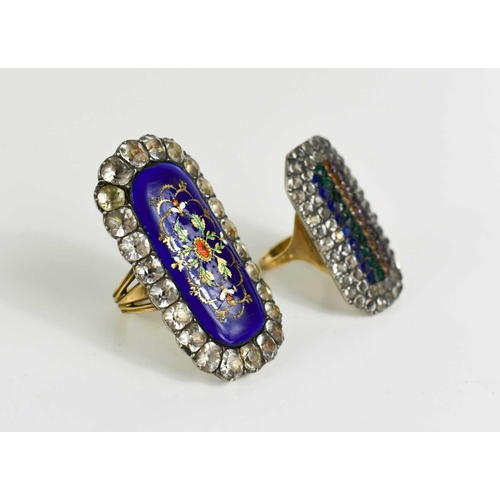 24 - Two Victorian white metal and paste set rings, one with blue enamel elongated oval centre embellishe... 