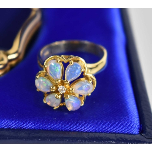 282 - An opal flowerhead ring, silver gilt, together with an Orient Express Stratton compact together with... 