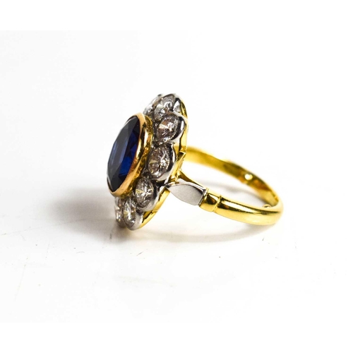 299 - An 18ct yellow gold, sapphire and diamond ring, the central oval cut deep cornflower blue sapphire o... 