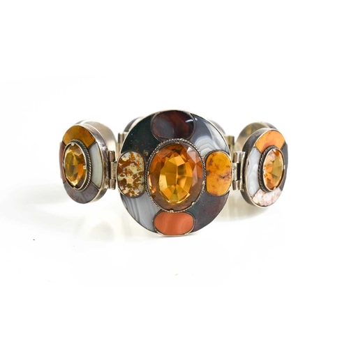 31 - A Scottish silver, agate and yellow topaz set bracelet, composed of seven oval links, each set with ... 