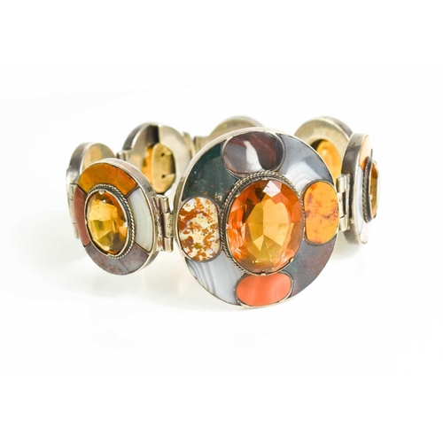 31 - A Scottish silver, agate and yellow topaz set bracelet, composed of seven oval links, each set with ... 