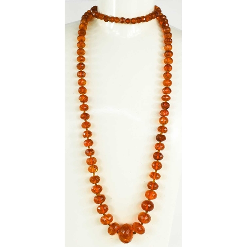 46 - A Victorian amber necklace with 9ct gold clasp, composed of faceted graduated beads, 69g.