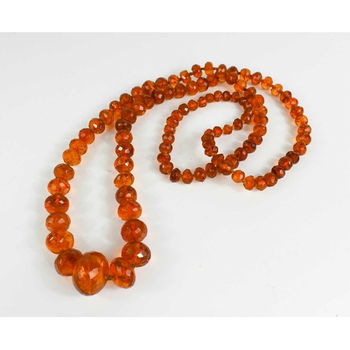 46 - A Victorian amber necklace with 9ct gold clasp, composed of faceted graduated beads, 69g.