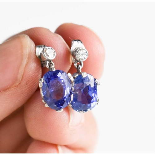 49 - A pair of white gold, blue sapphire and diamond stud earrings, 2.69g.