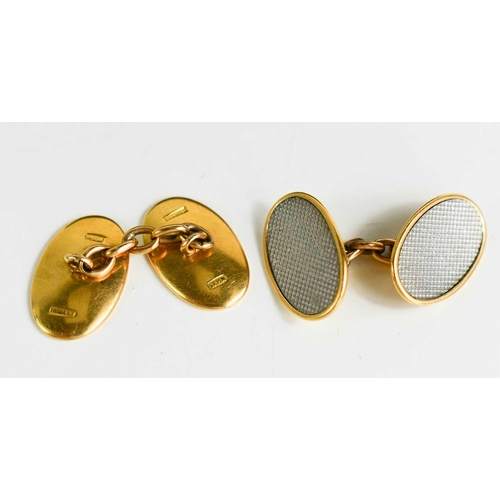 5 - A pair of 18ct yellow and white gold cufflinks, of oval form, with machine engraved decoration, in t... 